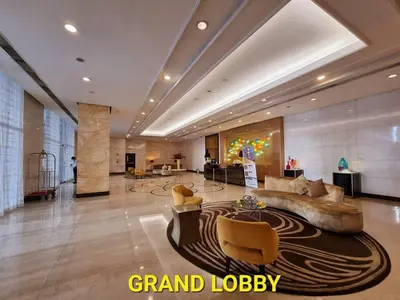 a lobby with a couch and chairs in a building at Chic BGC Condo by Grand Canal Mall #vlrtb27b in Manila