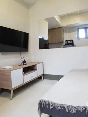 a bedroom with a flat screen tv and a bed at One Bedroom Condo Unit Fame Residences Tower 4 in Manila