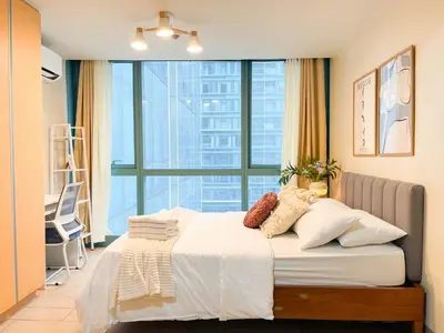 a bedroom with a bed with a large window at Luxury BGC Condo Across Uptown Mall #ournw19a in Manila