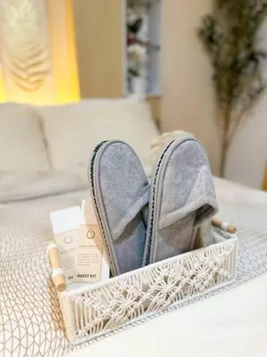 a pair of shoes sitting on a bed at Casa Alivia at Azure UrbanResort in Manila