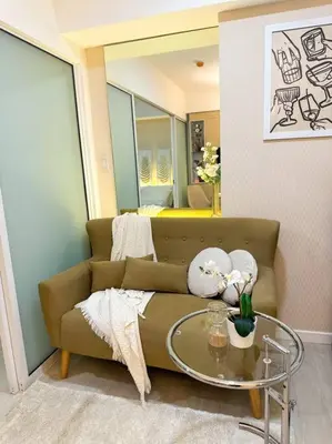 a living room with a couch and a glass table at Casa Alivia at Azure UrbanResort in Manila