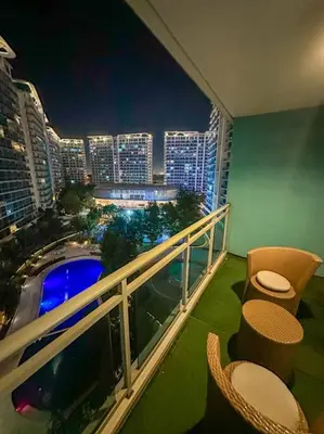 a balcony with a view of a city at night at Casa Alivia at Azure UrbanResort in Manila