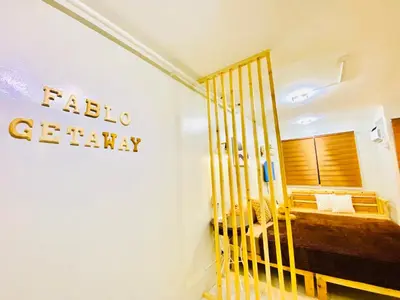 a hotel room with a crib in a bedroom at Fablo Getaway Staycation in Santa Rosa