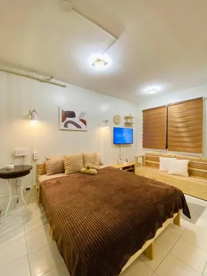 a bedroom with a large bed and a television at Fablo Getaway Staycation in Santa Rosa