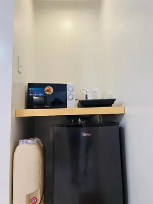 a kitchen with a counter with a microwave and a refrigerator at Fablo Getaway Staycation in Santa Rosa
