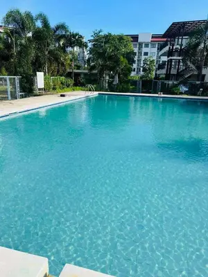 a large pool of blue water in front of a building at Fablo Getaway Staycation in Santa Rosa