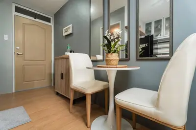 a living room with a table and two chairs at Newly Renovated Pasig Studio with Pool and Fiber Wi-Fi in Manila