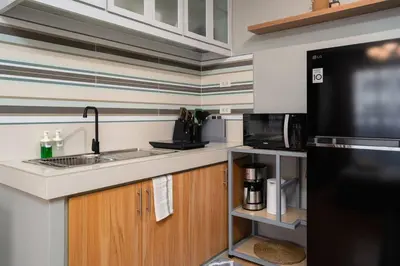 a kitchen with a sink and a microwave at Newly Renovated Pasig Studio with Pool and Fiber Wi-Fi in Manila