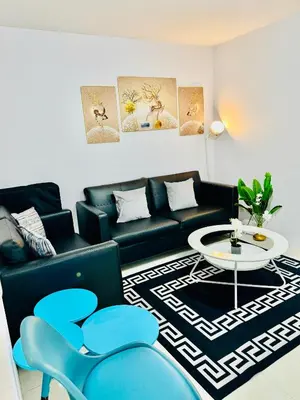 a living room with a couch and a table at Comfy 1BR Across International Airport in Manila