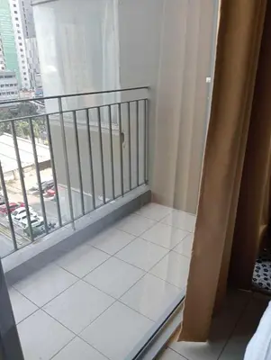 a room with a balcony with a view of a city at Studio deluxe cozy staycation Antel Spa Residences in Manila