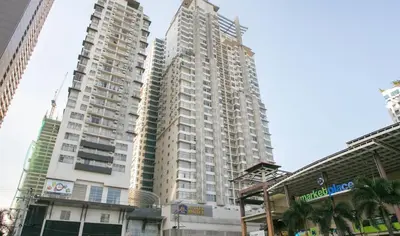 a tall apartment building with two tall buildings at Studio deluxe cozy staycation Antel Spa Residences in Manila