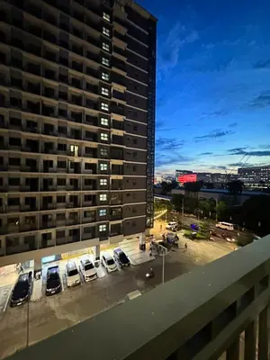 a view of a parking lot with cars parked in front of a building at shore staycation 559 in Manila