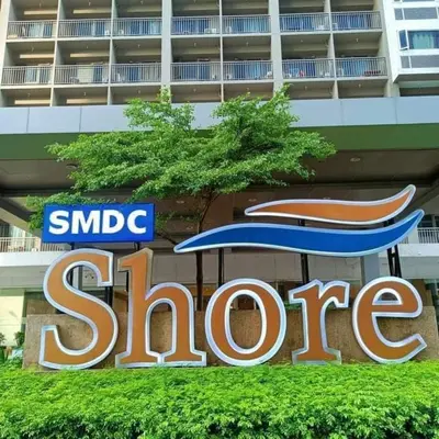 a sign for a store in front of a building at shore staycation 559 in Manila