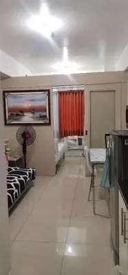 a large living room with a couch and a window at Moa Staycation pasay by mj in Manila