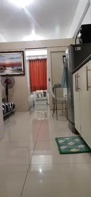 a large living room with a table and a couch at Moa Staycation pasay by mj in Manila