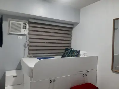 a white room with a bed and a window at Hotel in Mandaluyong in Manila