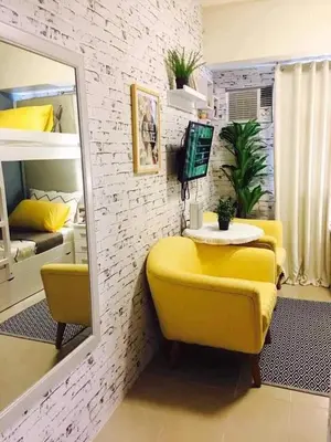 a room with a yellow chair and a mirror at Hotel in Mandaluyong in Manila