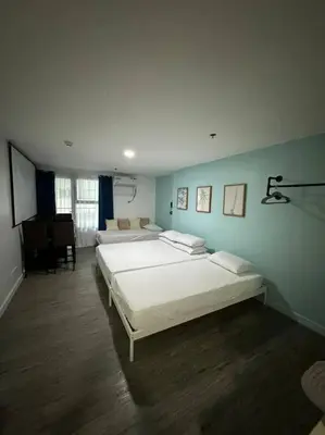 a large bedroom with two beds and a piano at Studio w projector Wifi Netflix and pool access in ADB Tower Ortigas CBD in Manila