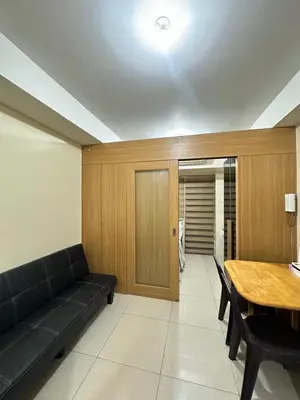 a living room with a couch and a table at shell staycation in Manila