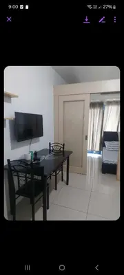 a living room with a black table and a couch at Sea res moa by Elsie D in Manila