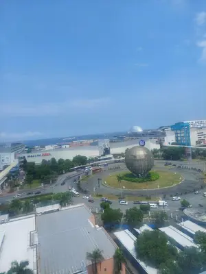an aerial view of a city with a large building at Sea res moa by Elsie D in Manila