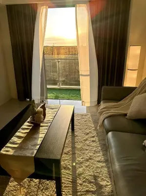 a living room with a coffee table in front of a window at Luxury Hotel near City of Dreams, Solaire, NAIA, and MOA - City of Bridge in Manila