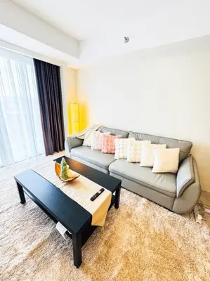 a living room with a couch and a coffee table at Luxury Hotel near City of Dreams, Solaire, NAIA, and MOA - City of Bridge in Manila