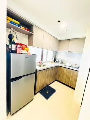 a kitchen with a refrigerator and a scale on the floor at Luxury Hotel near City of Dreams, Solaire, NAIA, and MOA - City of Bridge in Manila