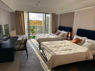 a hotel room with two beds and a window at Luxury Hotel near City of Dreams, Solaire, NAIA, and MOA - City of Bridge in Manila