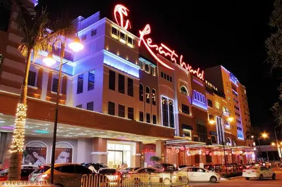 a building with neon signs on the side of it at Newport City Condos in Manila