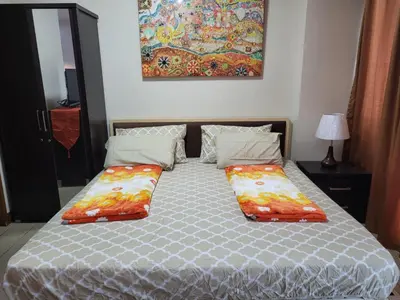 a bed with two pillows on it in a bedroom at Newport City Condos in Manila
