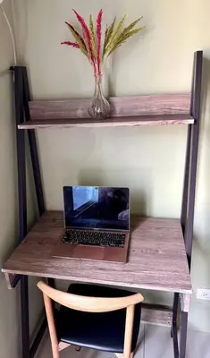 a laptop computer sitting on top of a wooden table at Tropical Haven in Makati CBD in Manila