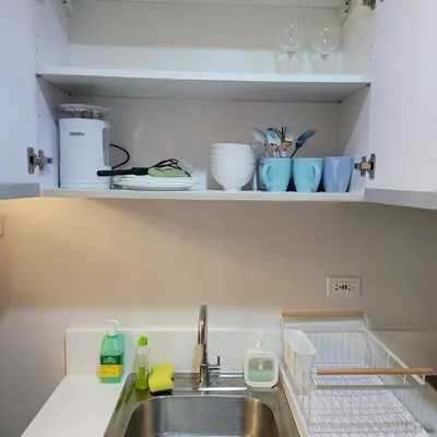 a kitchen counter with a sink and some dishes at Air Residences - Pool View Balcony near Airport - 4576 in Manila