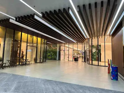 a lobby with a large building withwindows and a lobby at Air Residences - Pool View Balcony near Airport - 4576 in Manila