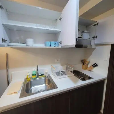 a kitchen with a sink and a counter top at Air Residences - Pool View Balcony near Airport - 4576 in Manila