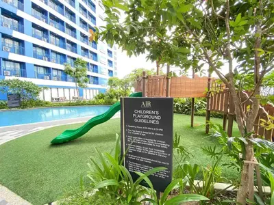 a sign in front of a swimming pool with a slide at Air Residences - Balcony Pool View near Airport - 1721 in Manila