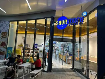 people sitting at tables outside of a save meat store at Air Residences - Balcony Pool View near Airport - 1721 in Manila