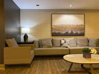a living room with a couch and a table at Air Residences - High Floor City View near Airport - 5759 in Manila