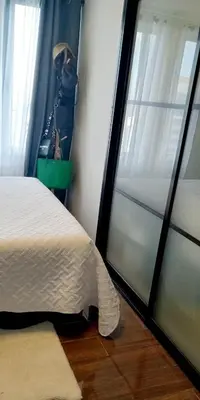 a bedroom with a bed and a window at Air Residences - High Floor City View near Airport - 5759 in Manila