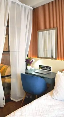 a bedroom with a desk with a bed and a mirror at Air Residences - High Floor City View near Airport - 5759 in Manila