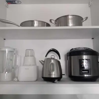 a kitchen shelf with a toaster and other kitchen appliances at SMDC Coast Residences in Manila
