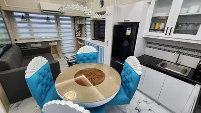 a kitchen and dining room with a table and chairs at SMDC Coast Residences in Manila