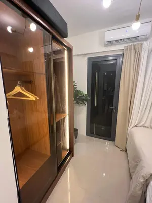 a room with a glass closet and a bed at Shore 2 Tower 3 in Manila