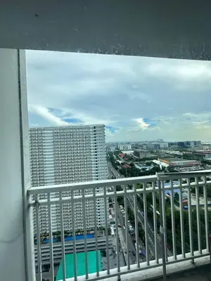 a view of a city from a balcony of a building at Lanz staycation breeze residences in Manila