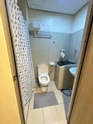 a small bathroom with a toilet and a sink at Lanz staycation breeze residences in Manila
