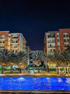 a large pool of blue water in front of buildings at Condotel Near Airport Terminals in Manila