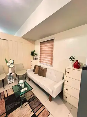 a living room with a couch and a table at SM Jazz Residence Tower B in Manila