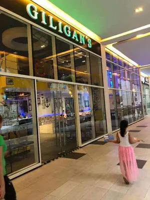 a little girl walking in front of a store at Ivy Condotels Unit -101Newport Boulevard in Manila