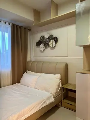 a bedroom with a bed with a teddy bear on the wall at Twin Duckworth Suites T3 in Manila