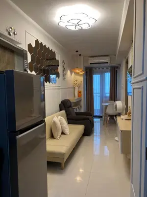 a living room with a couch and a kitchen at Twin Duckworth Suites T3 in Manila